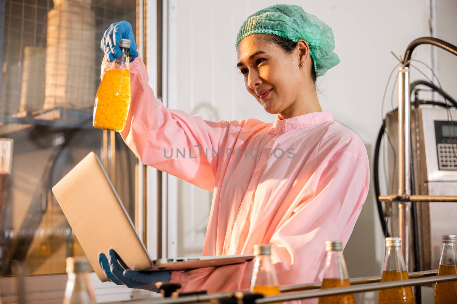 Quality inspector a woman carefully examines beverage bottles on a conveyor by Sorapop