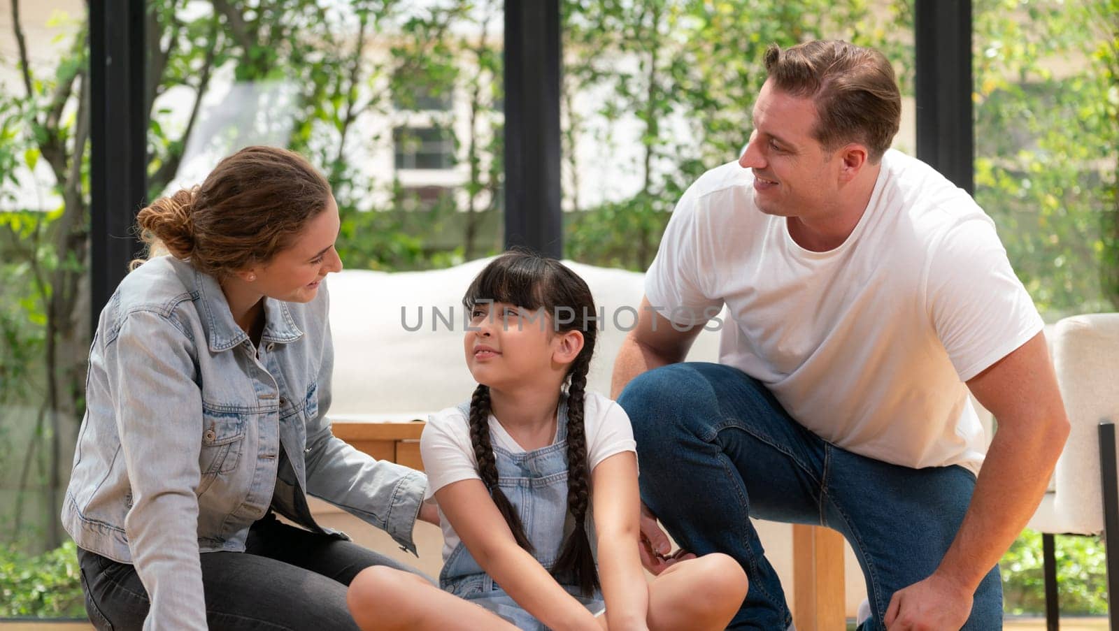 Parents comforting their daughter with loving embrace, helping her feel secure and protected as she rest her head on their shoulder. Happy family love and child care support Panorama. Synchronos