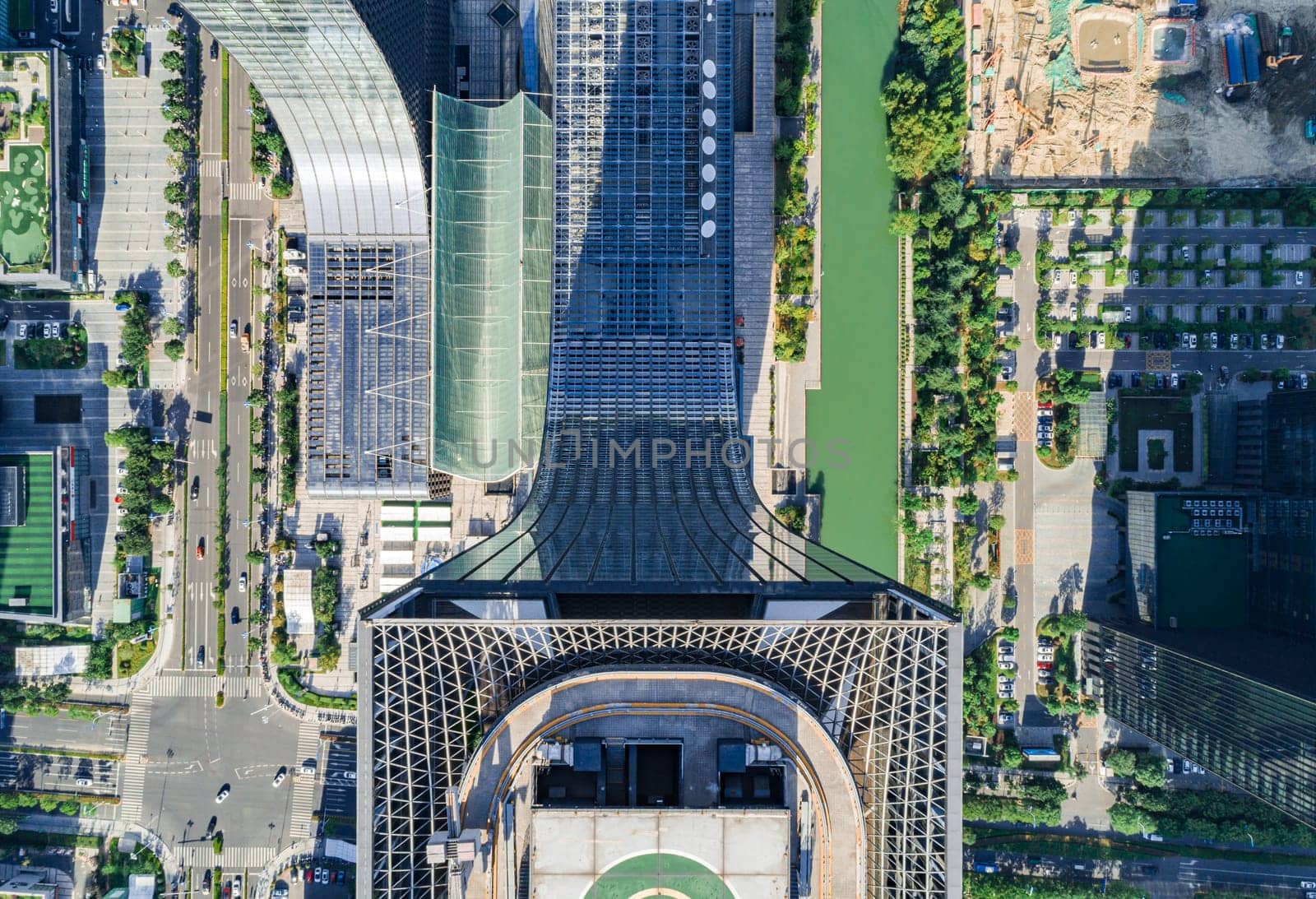 Aerial drone view of helipad on the roof of a skyscraper in downtown.