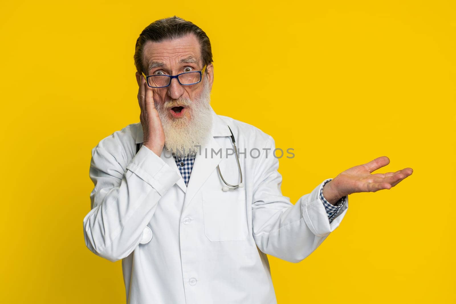 Oh my God Wow. Excited amazed winner senior elderly doctor cardiologist man surprise looking at camera big eyes shocked by victory celebrating success. Apothecary pharmacy grandfather. Copy-space