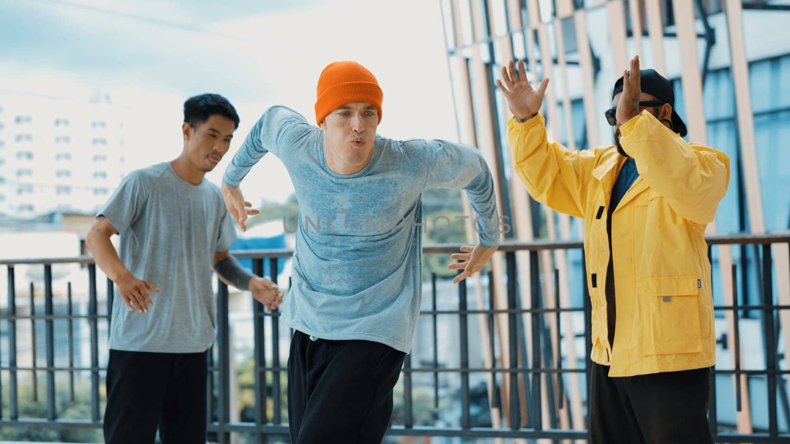 Hip hop team dance break dance while multicultural friend surrounded and clapping hands to cheer or encourage his friend to dance. Active and energetic street dance. Outdoor sport 2024. Endeavor.