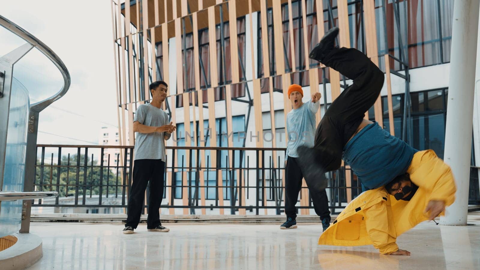Hip hop team dance break dance while multicultural friend surrounded and clapping hands to cheer or encourage his friend to dance. Active and energetic street dance. Outdoor sport 2024. Endeavor.