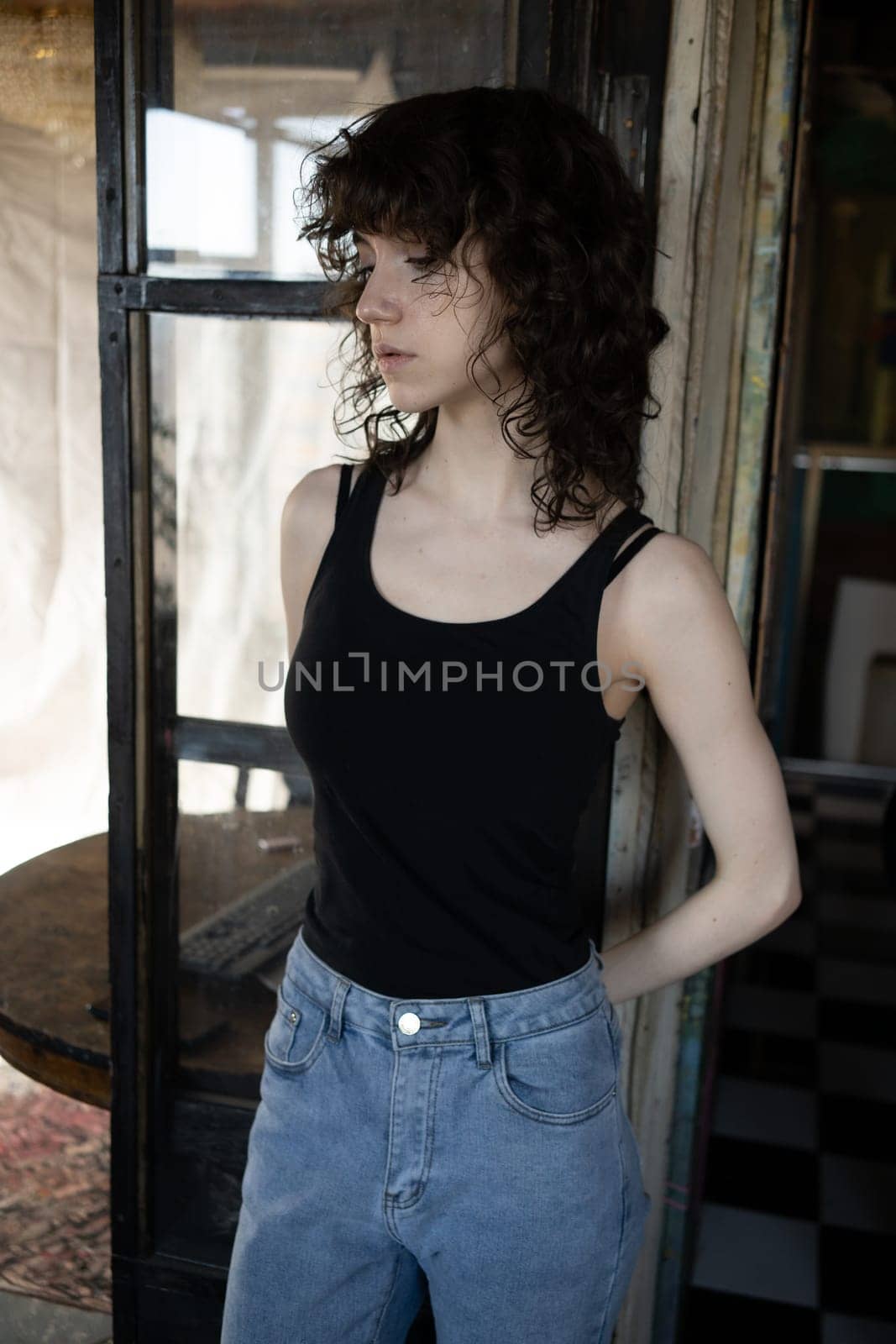 young beautiful woman posing in blue jeans in studio