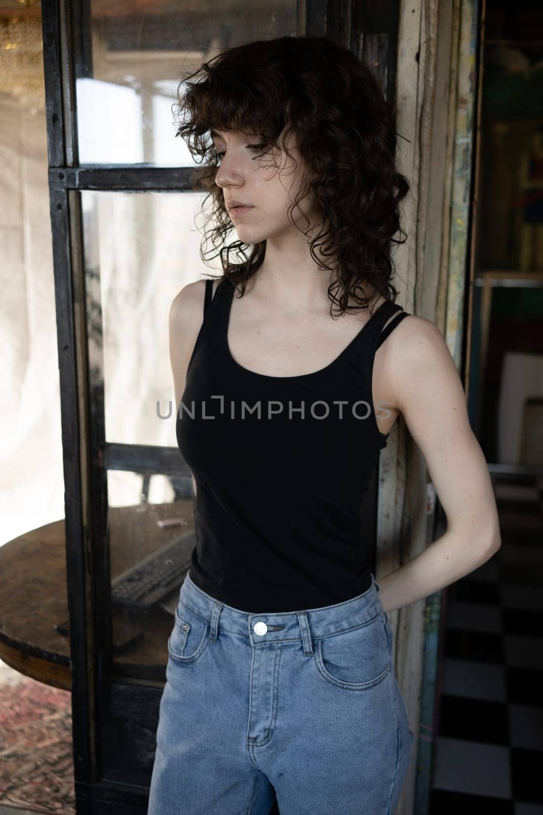 young beautiful woman posing in blue jeans in studio