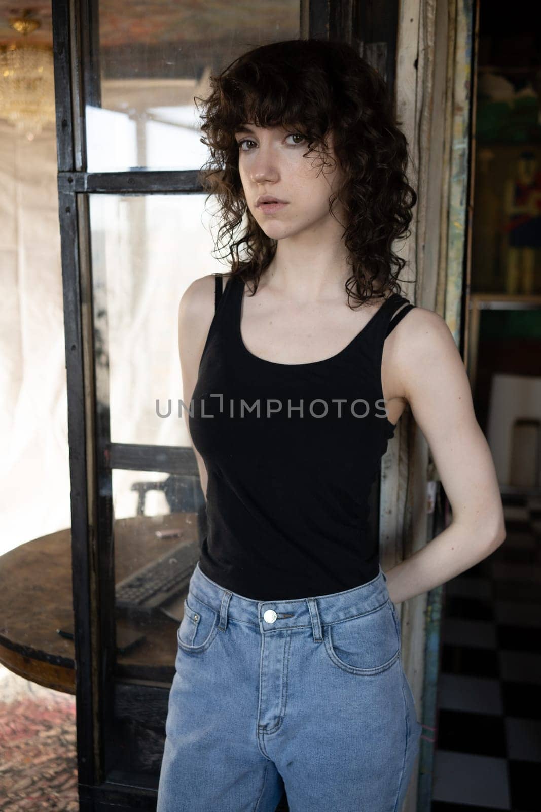 young beautiful woman posing in blue jeans in studio