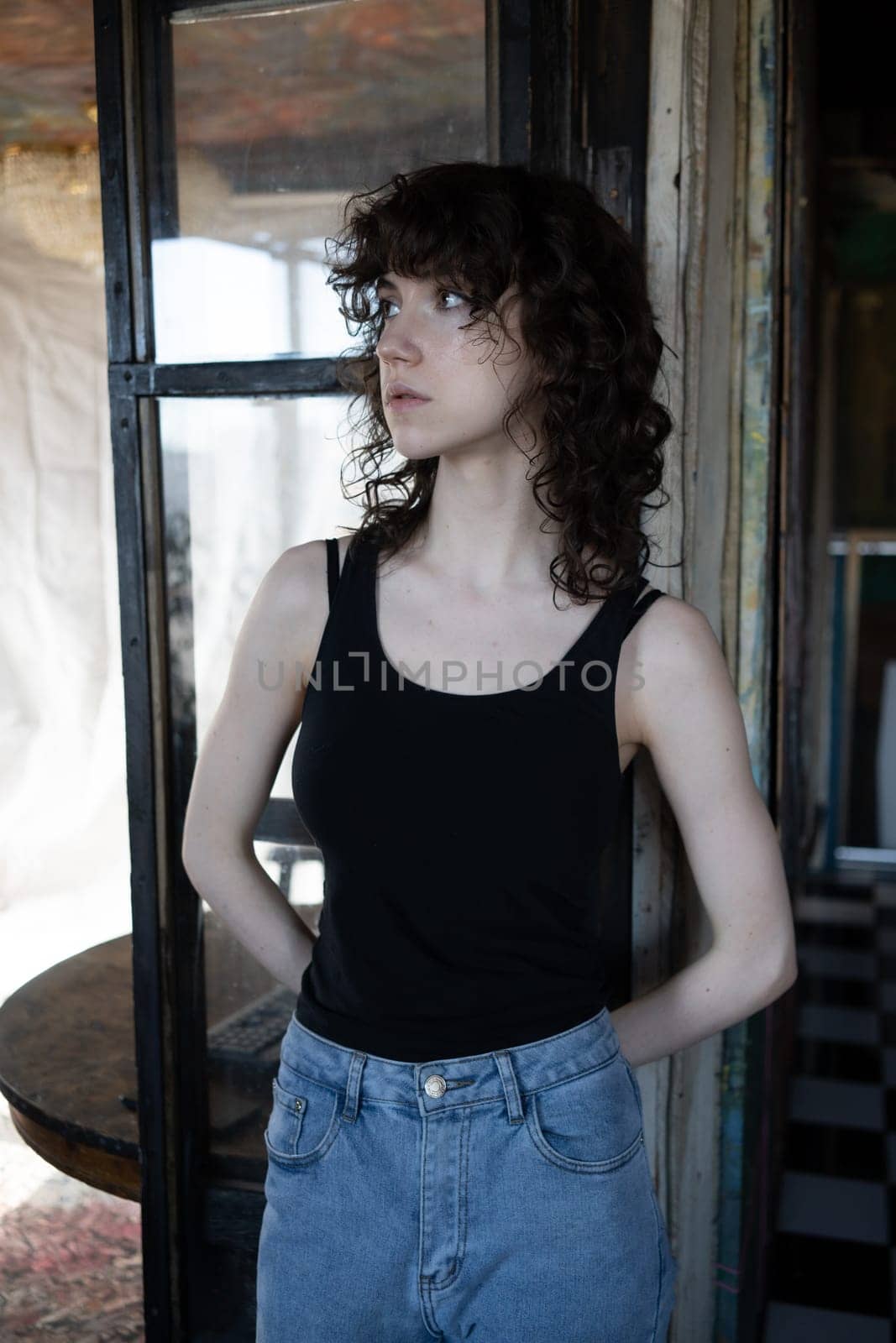 young beautiful woman posing in blue jeans in studio