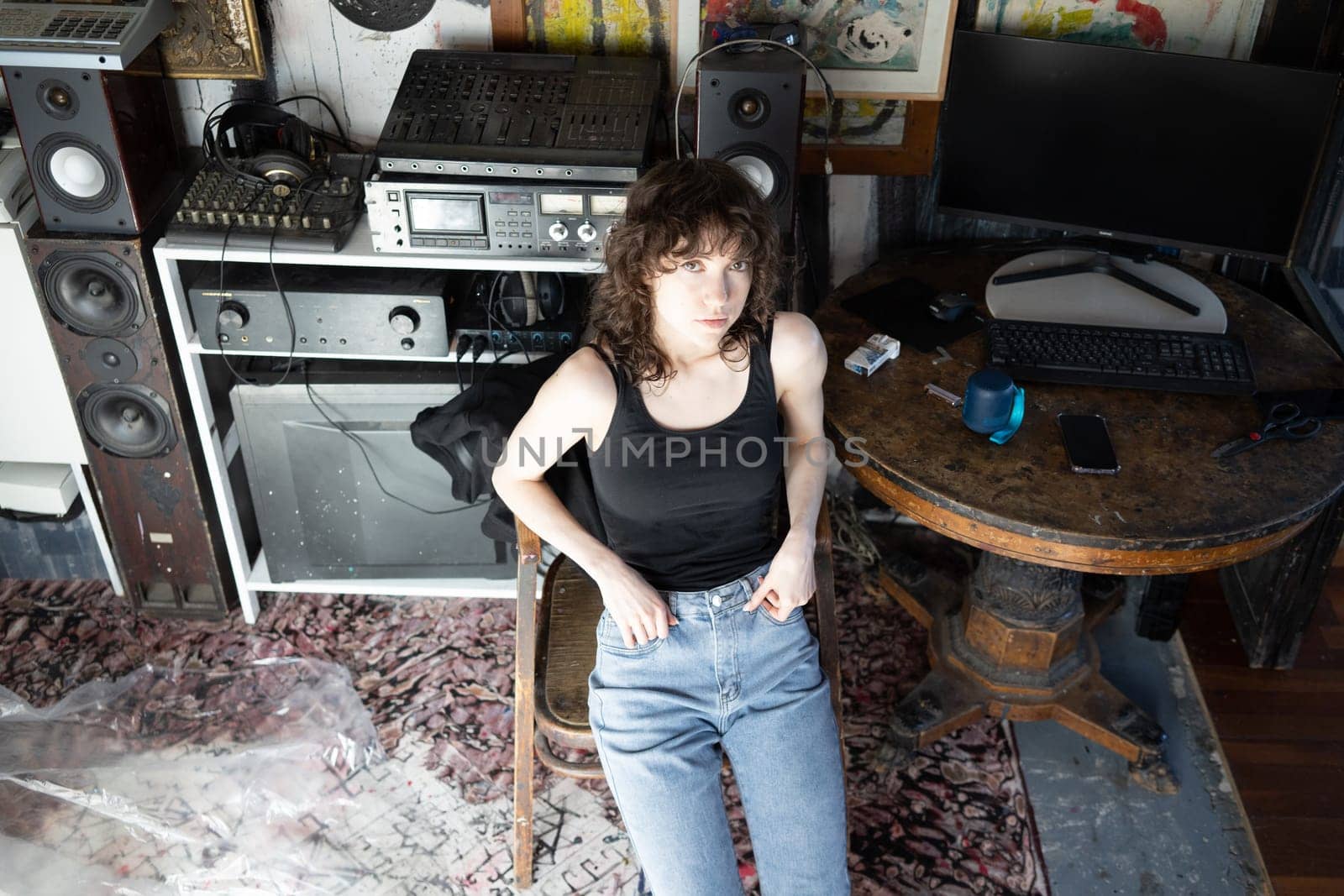 young beautiful woman posing in blue jeans in studio