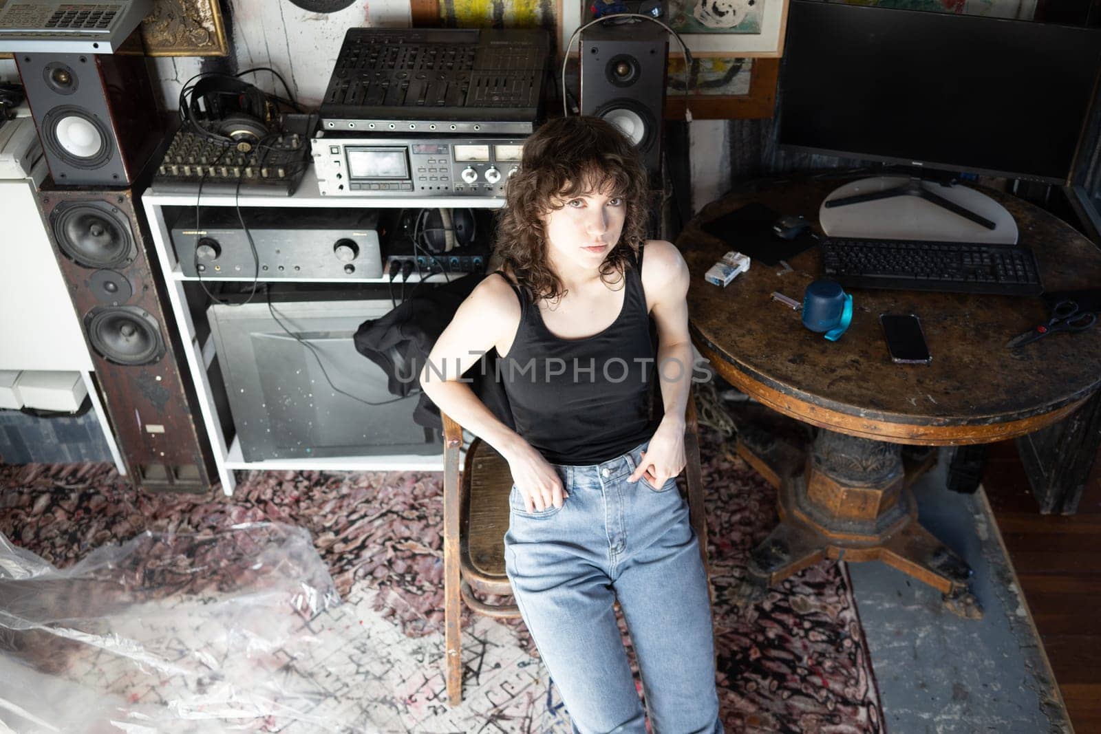 young beautiful woman posing in blue jeans in studio