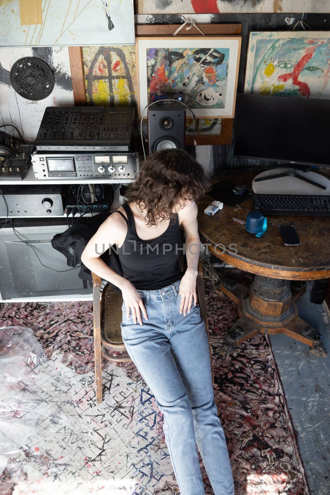 young beautiful woman posing in blue jeans in studio