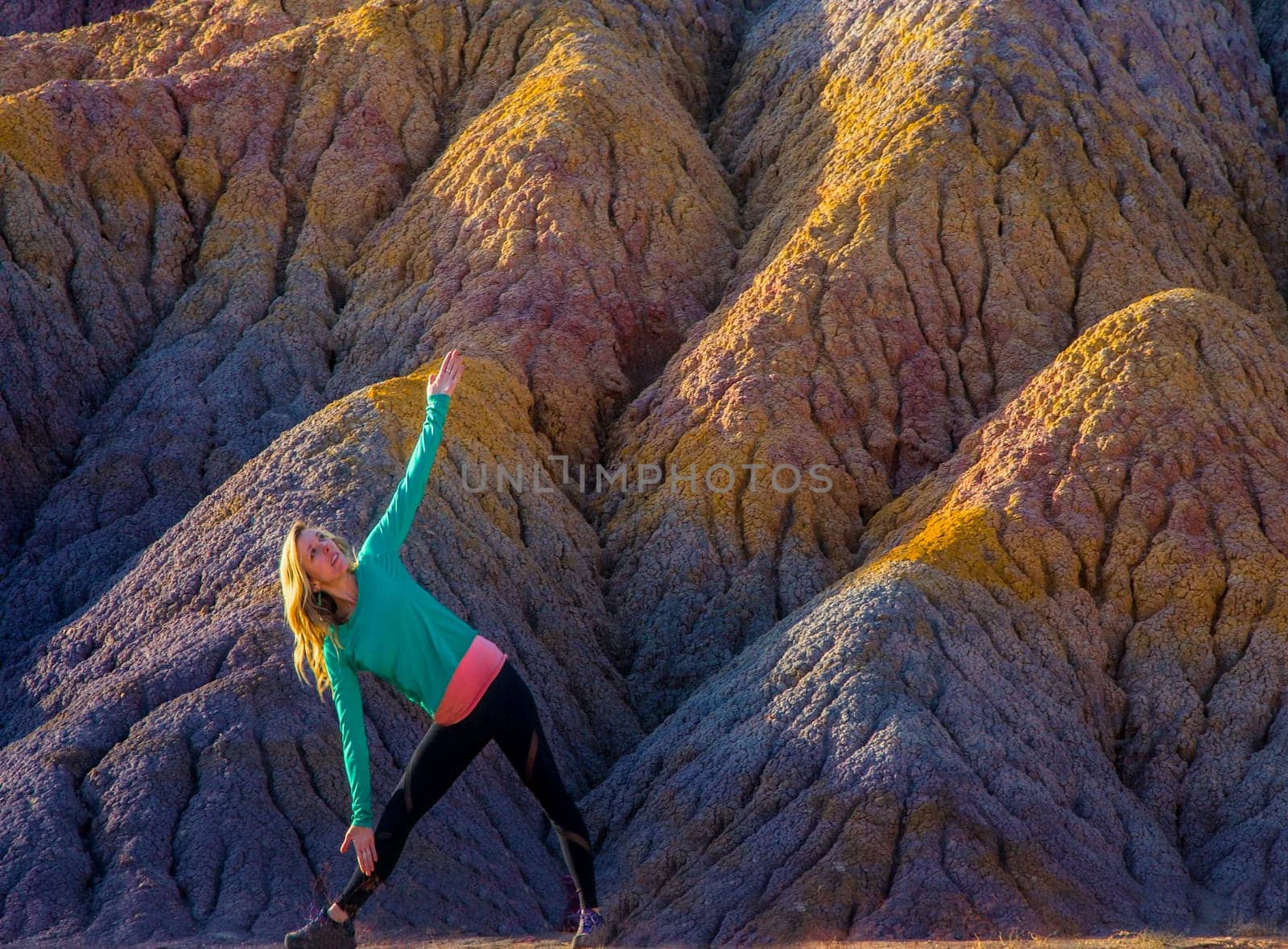A woman stretches in a yoga pose at Clay Beds in Southern Utah