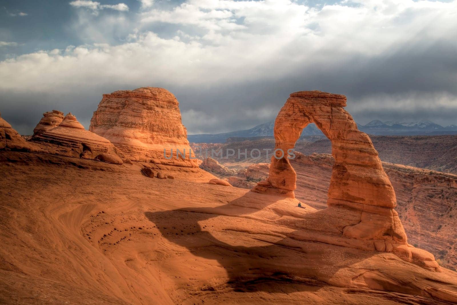 Delicate Arch stands prominent during threatening skies at Arches National Park, Utah