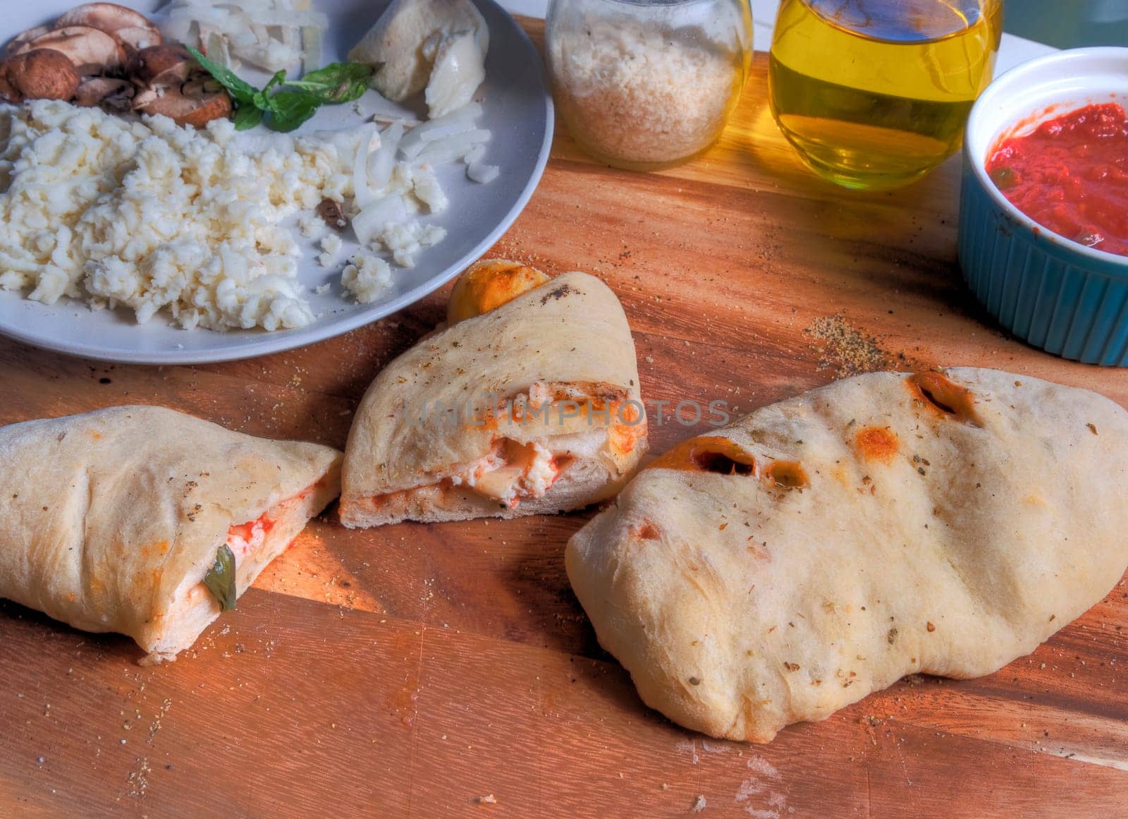 Side view of calzone slices on butcher block surface