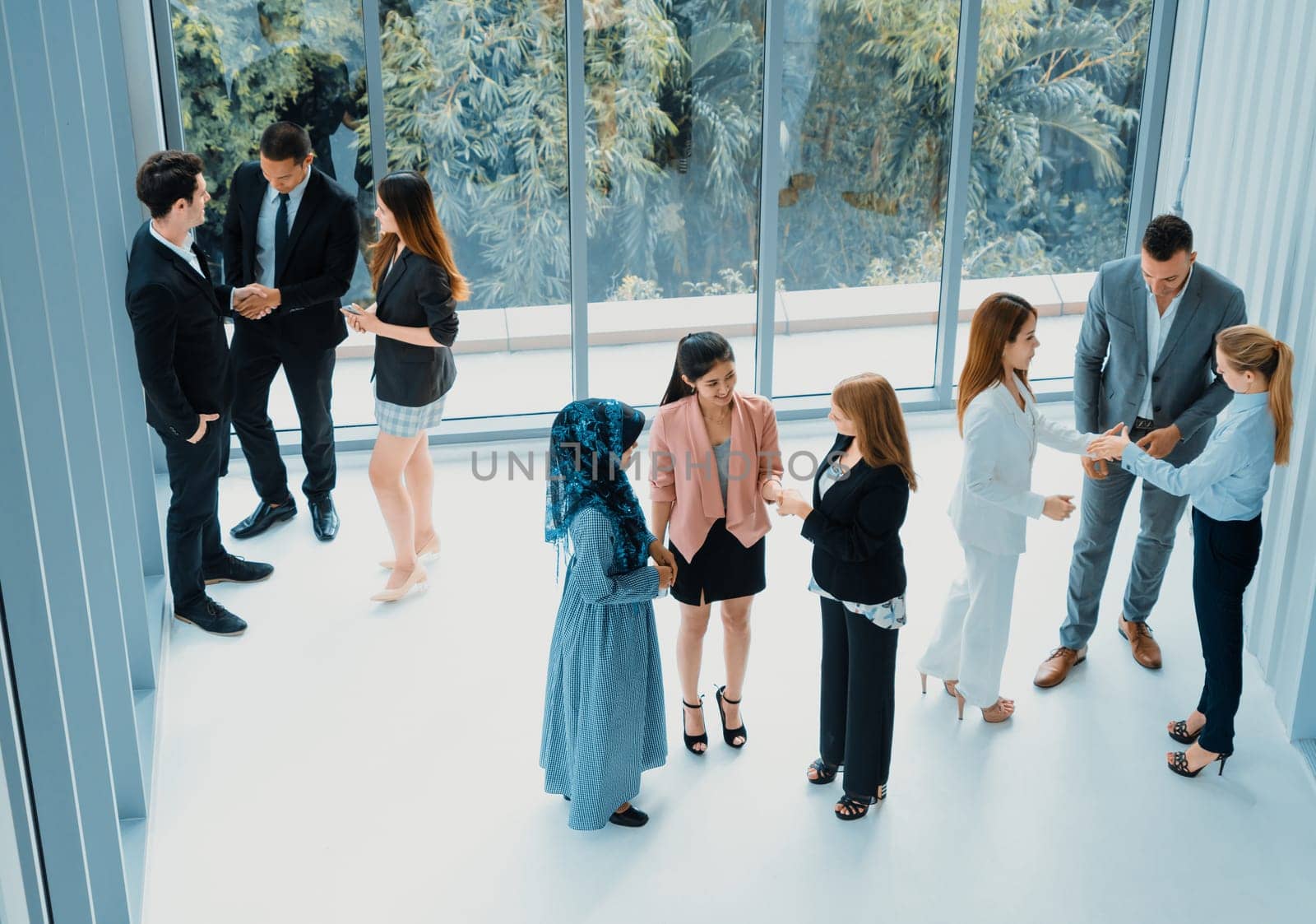 Many business people gathering in modern office building for business conference in the city. Businessmen and businesswomen communication and human resources concept. uds