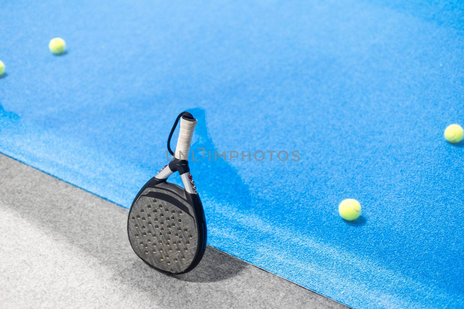 Padel tennis racket. Background with copy space. Sport court and balls. by Andelov13