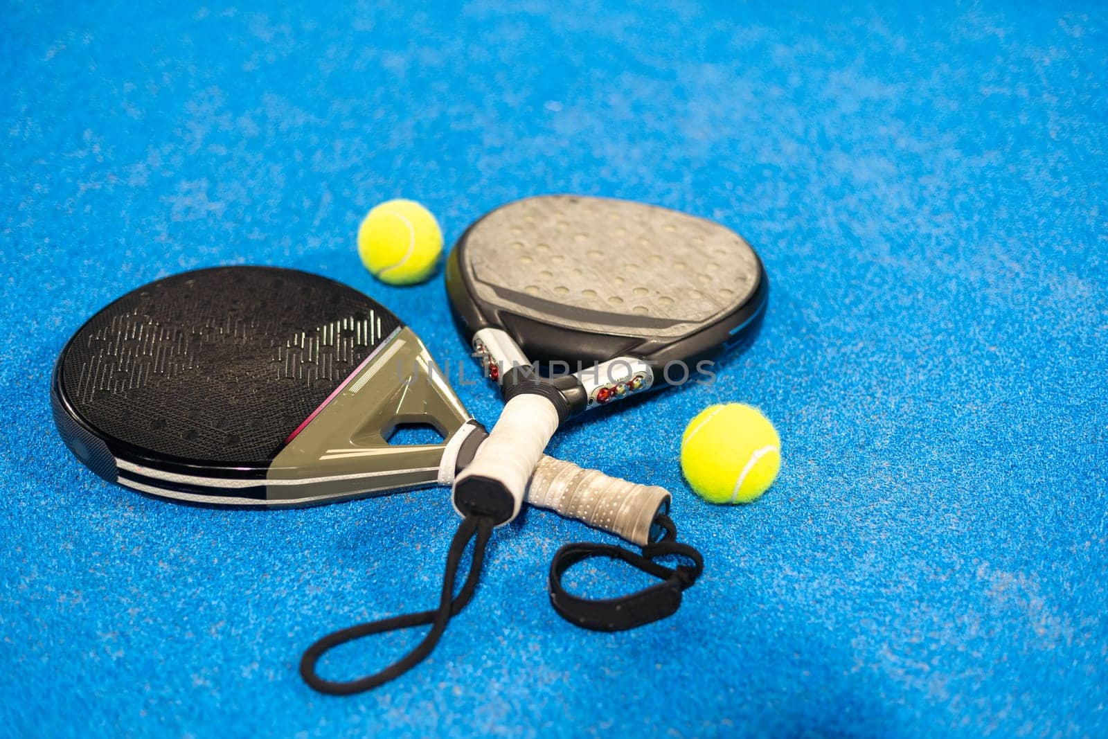 rackets paddle with two balls on blue background. High quality photo