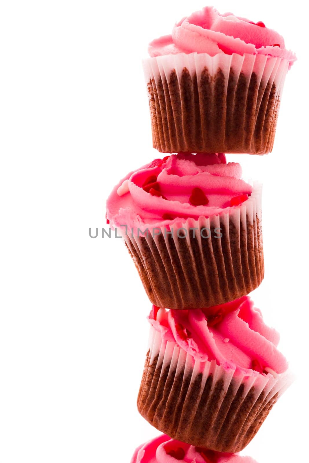 Stack of pink cupcakes on white background.