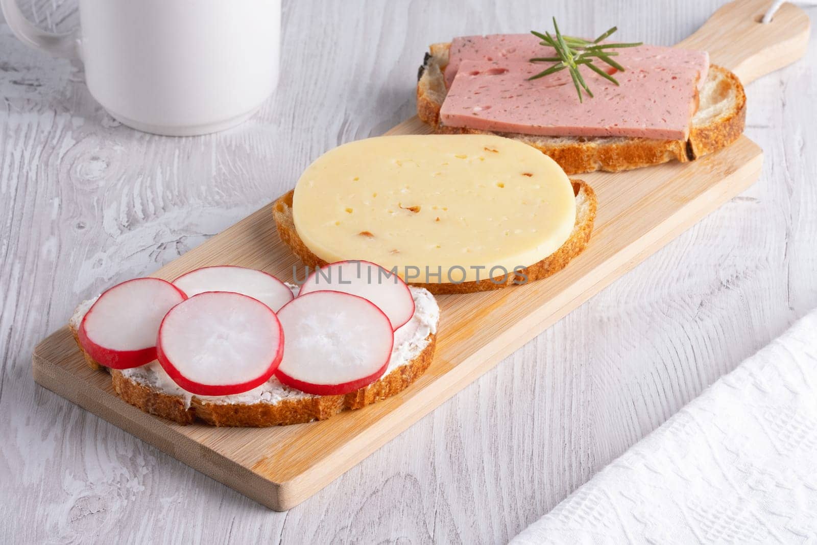 Sandwiches with radishes, cottage cheese, cheese and sausage.