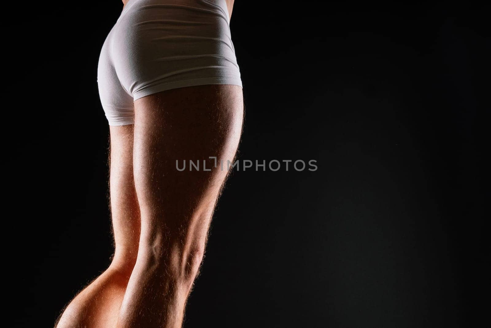 Male muscular legs body-building, muscle man in a white sport panties