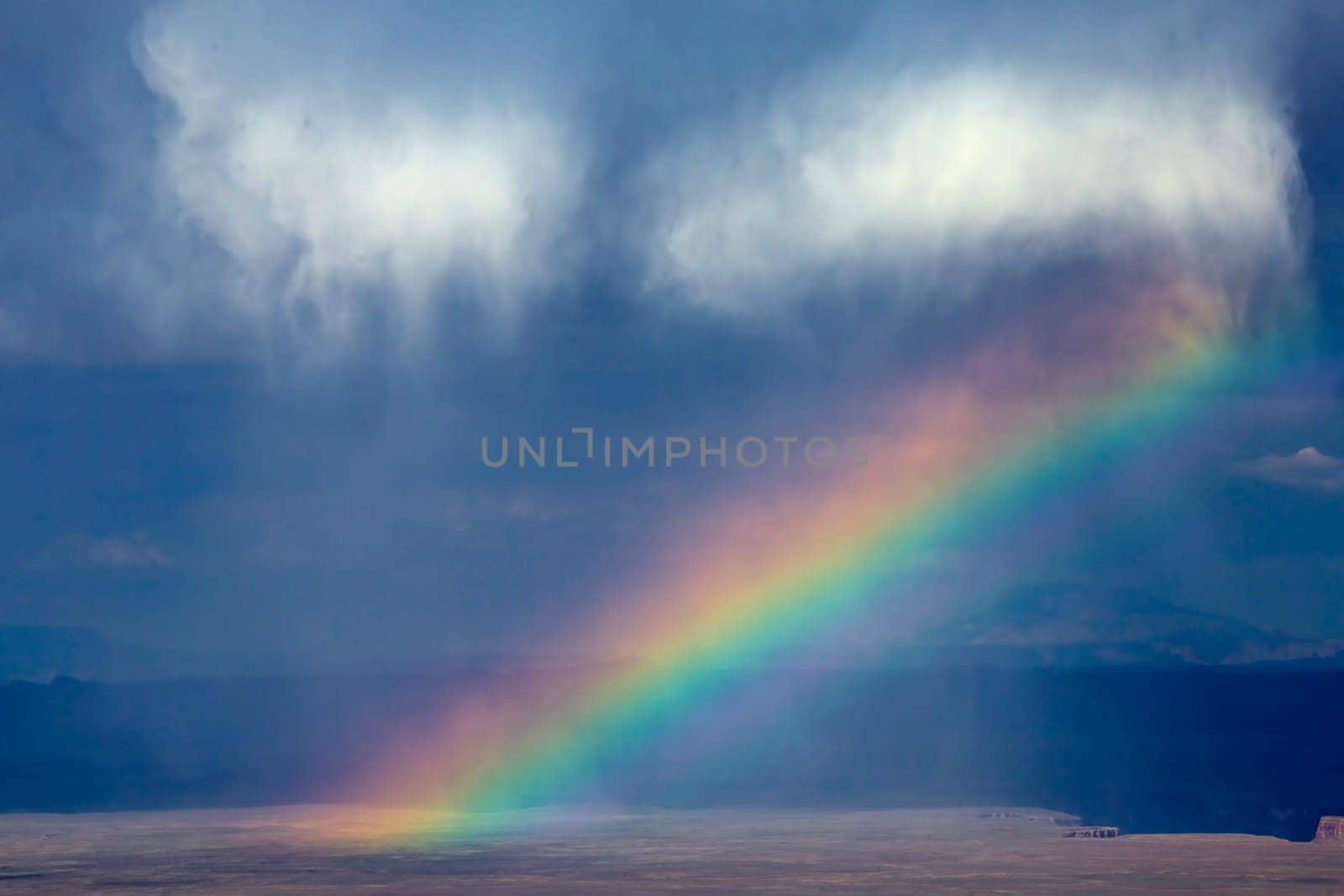 A rainbow appears during a thunderstorm at Marble Canyon at Grand Canyon National Park, Arizona.