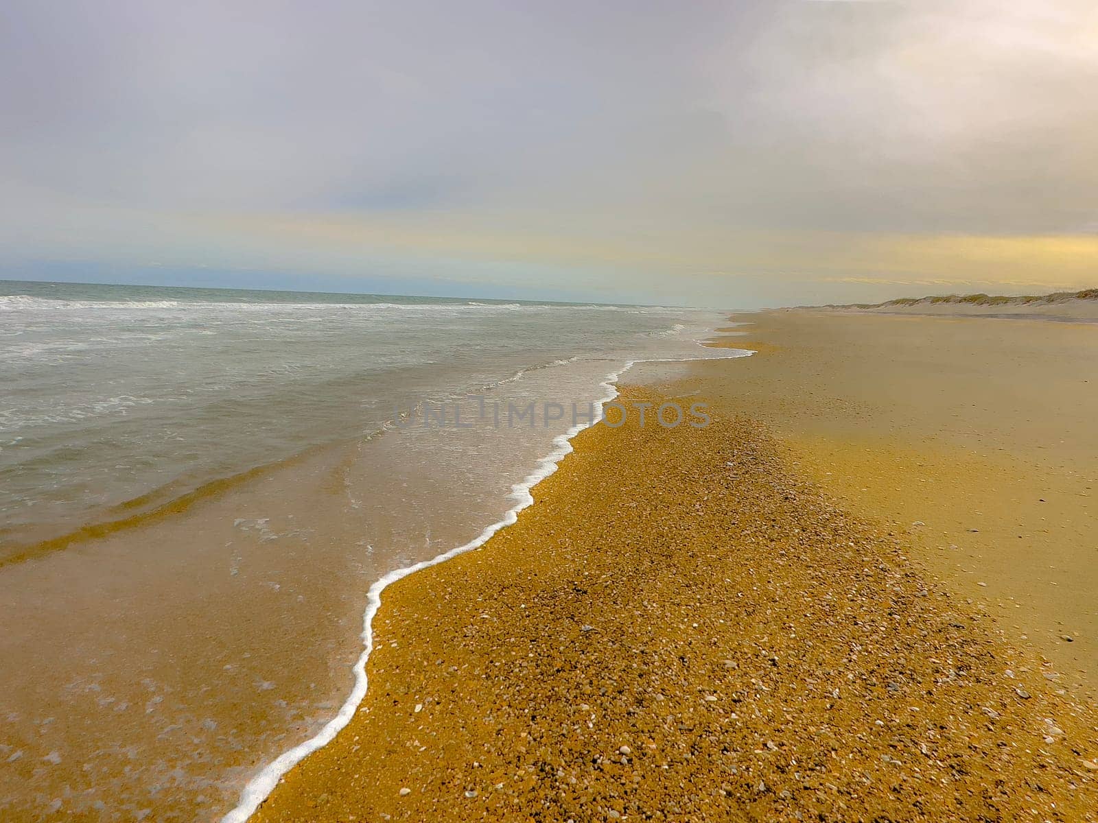 Sand Dunes and Ocean Waves make up the scene at Cape Hatteras National Seashore, North Carolina