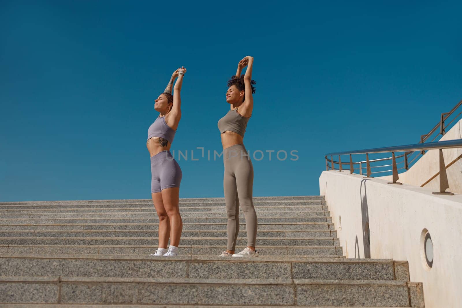 Fit women does warm-up exercises in morning before running training outside. Healthy fitness by Yaroslav_astakhov