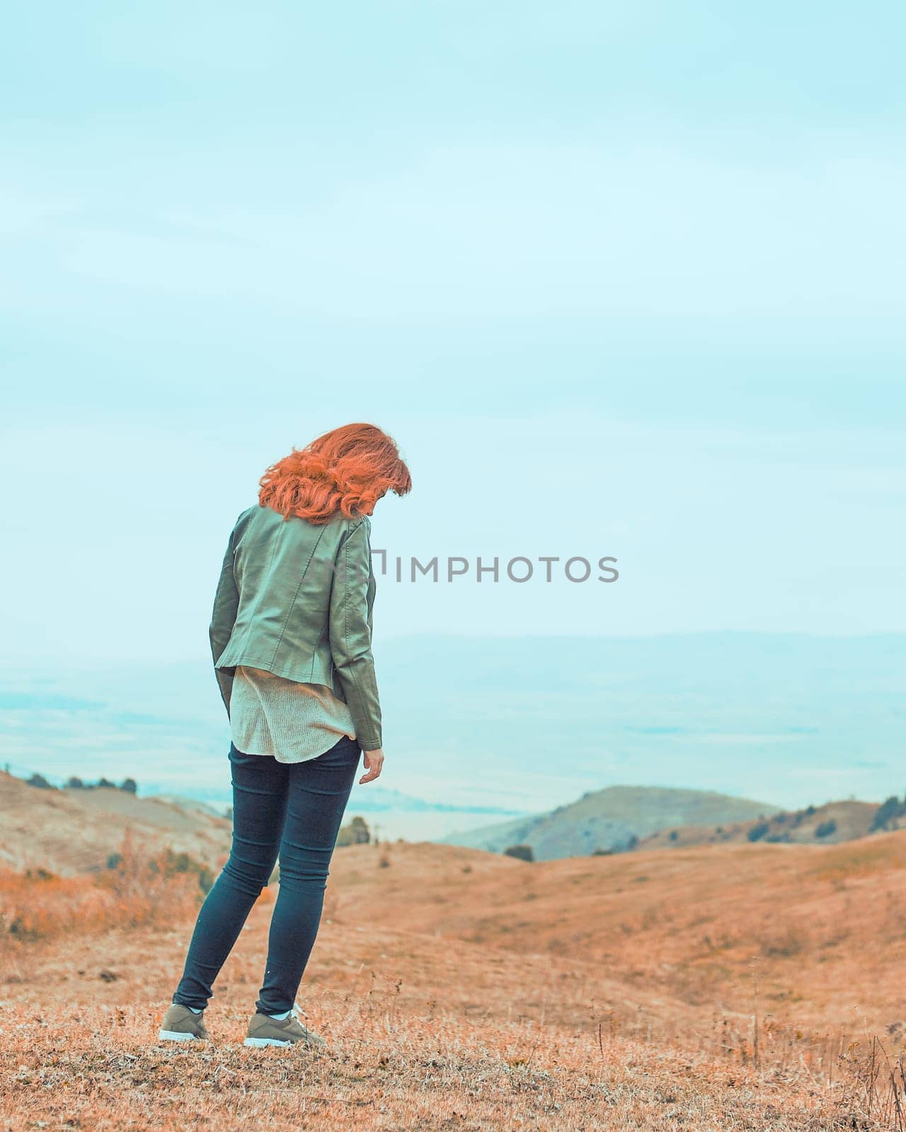 Beauty woman outdoors enjoying nature. Pretty young woman in field at bad weather.