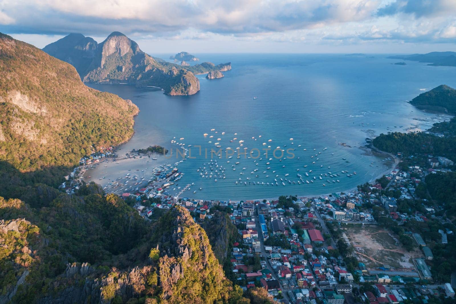 Aerial drone view over mountain with tropical lagoon on the background on sunset. El Nido, Palawan.