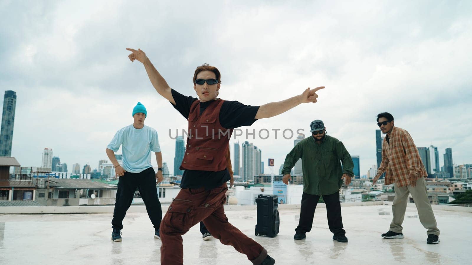 Professional break dance team practice B-boy dance while multicultural friends at rooftop. Young modern dancing group doing hip hop movement. Style,fashion,action. Outdoor sport 2024. Endeavor.
