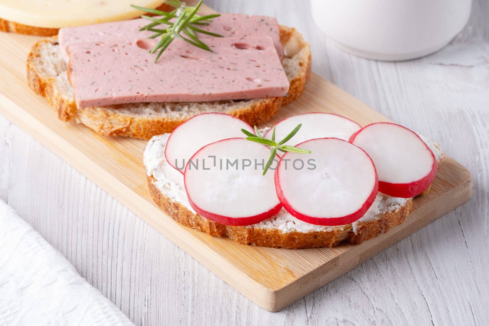 Sandwiches with radishes, cottage cheese and sausage.