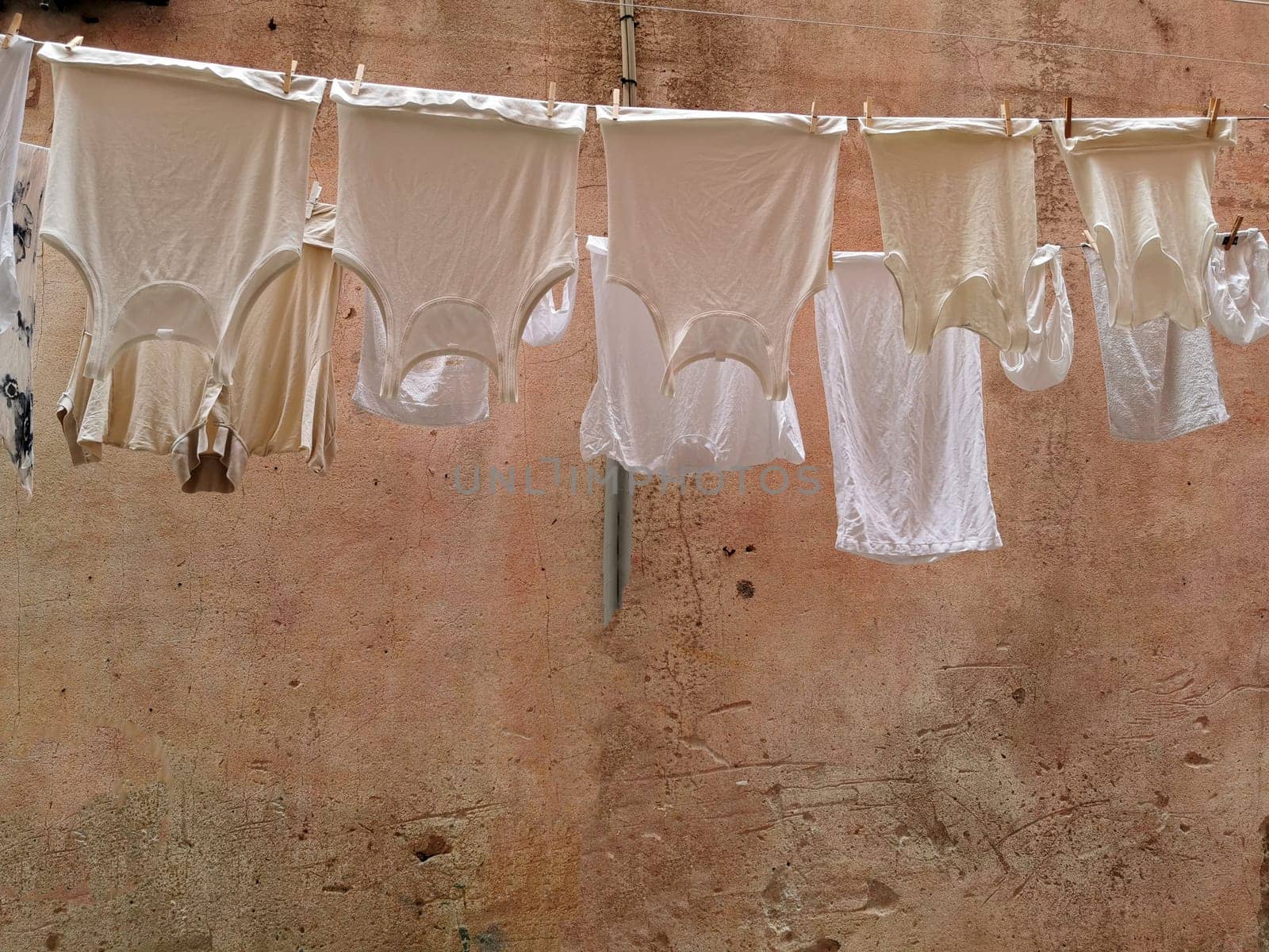 clothes hanging to dry in italian pictoresque village by AndreaIzzotti
