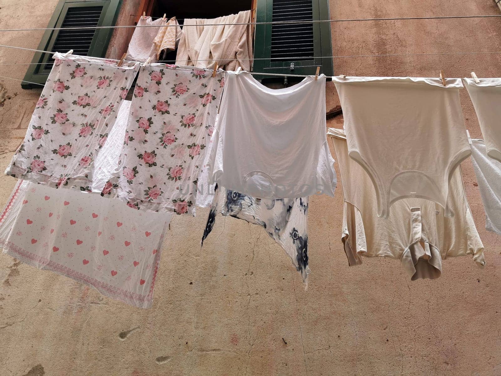 clothes hanging to dry in italian pictoresque village by AndreaIzzotti