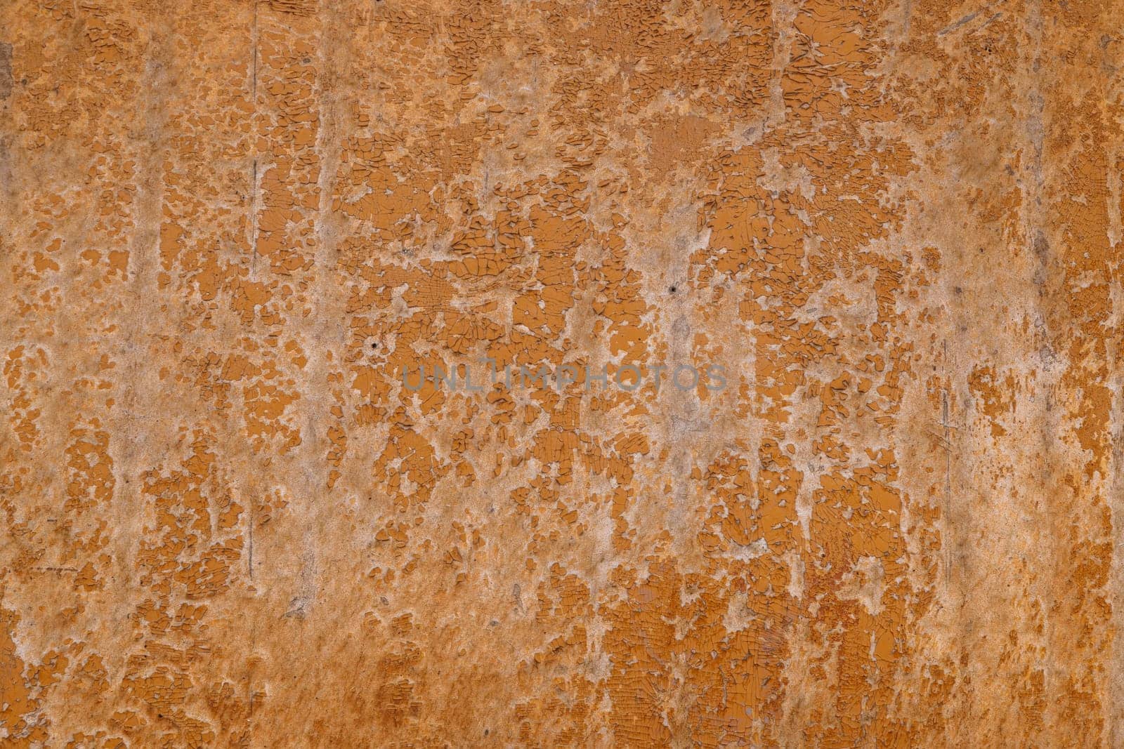 Closeup of a weathered brown fiberboard surface with peeled off brown paint, full-frame background and texture by z1b