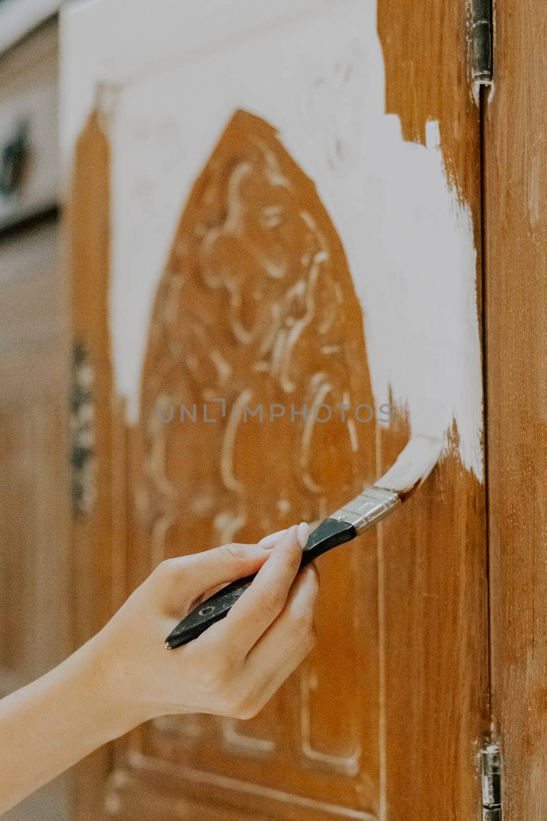 A young girl is painting an old closet. by Nataliya