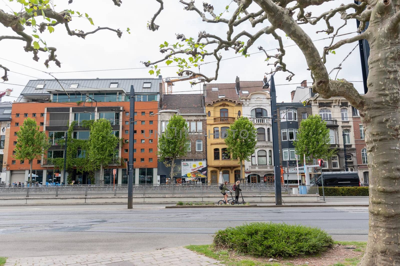 Ghent, Belgium, May 5, 2022: Beautiful houses in the center of Ghent near the train station, Modern city with tram by KaterinaDalemans