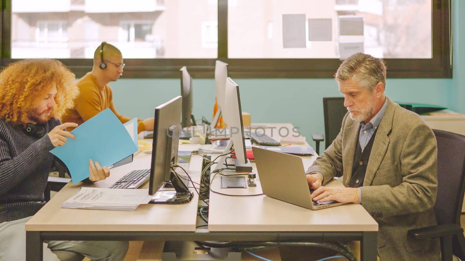 Group of diverse coworkers working in a shared table in a coworking