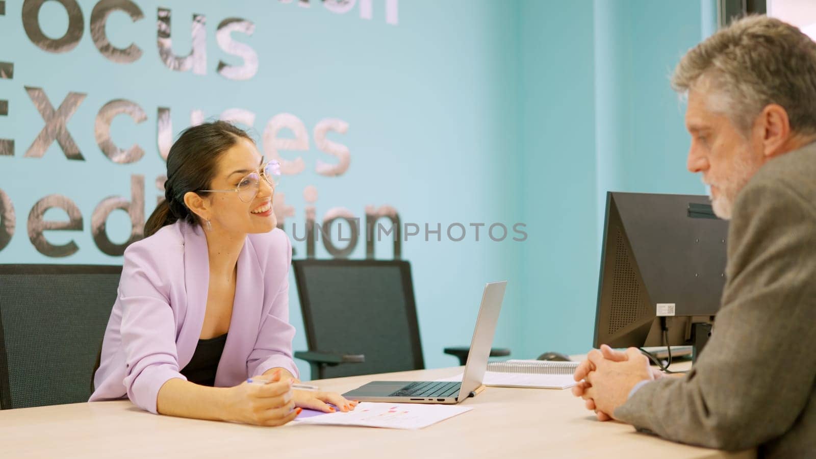 Smiling store saleswoman explaining something to a customer