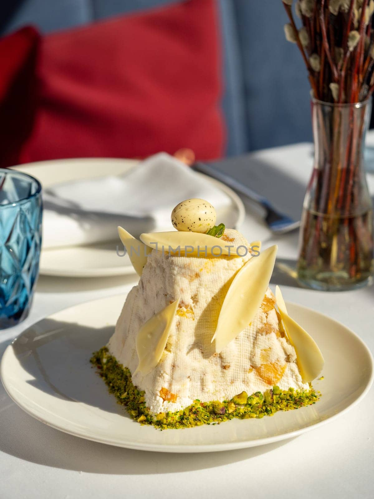 Traditional Easter cottage cheese dessert Paskha decorated with quail egg and chocolate on tabletop background. Modern Orthodox Easter background with mini cottage curd dessert Paskha