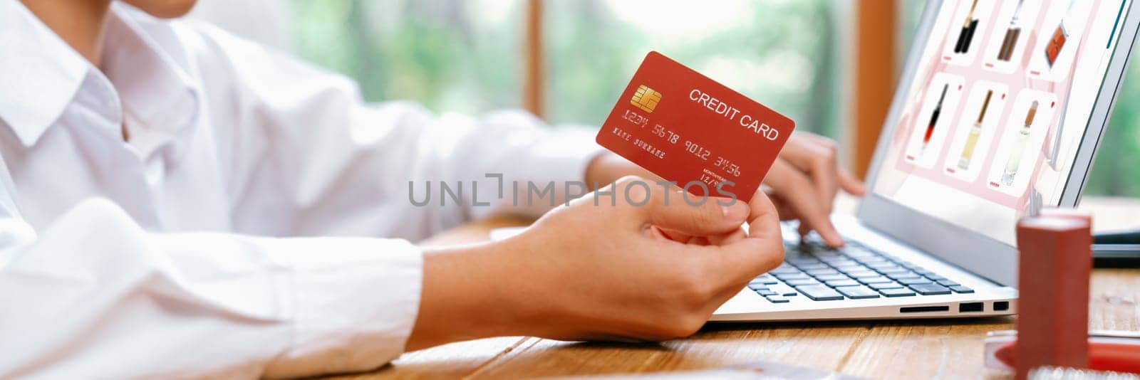 Woman shopping online on internet marketplace browsing for sale items for modern lifestyle and use credit card for online payment from wallet protected by uttermost cyber security software