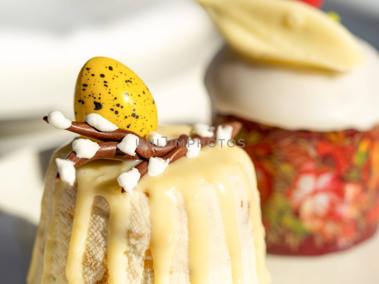 Traditional Easter cottage cheese dessert Paskha decorated with quail eggs and chocolate willow on tabletop background. Modern Orthodox Easter background with two mini cottage curd desserts Paskha