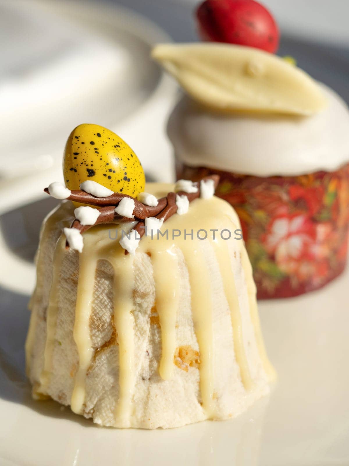 Traditional Easter cottage cheese dessert Paskha decorated with quail eggs and chocolate willow on tabletop background. Modern Orthodox Easter background with two mini cottage curd desserts Paskha