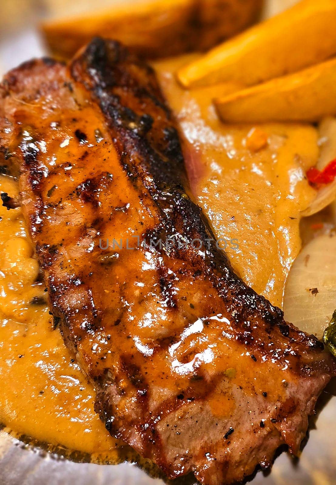 New york strip loin beef steak meat with mushroom sauce and potato wedges and salad plated on beautiful plate on a steak house