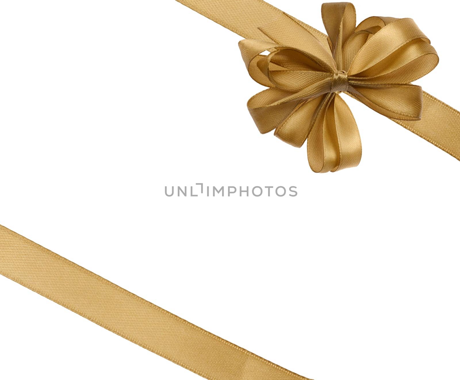 Tied bow made of golden silk ribbon on an isolated background, decor for a gift by ndanko