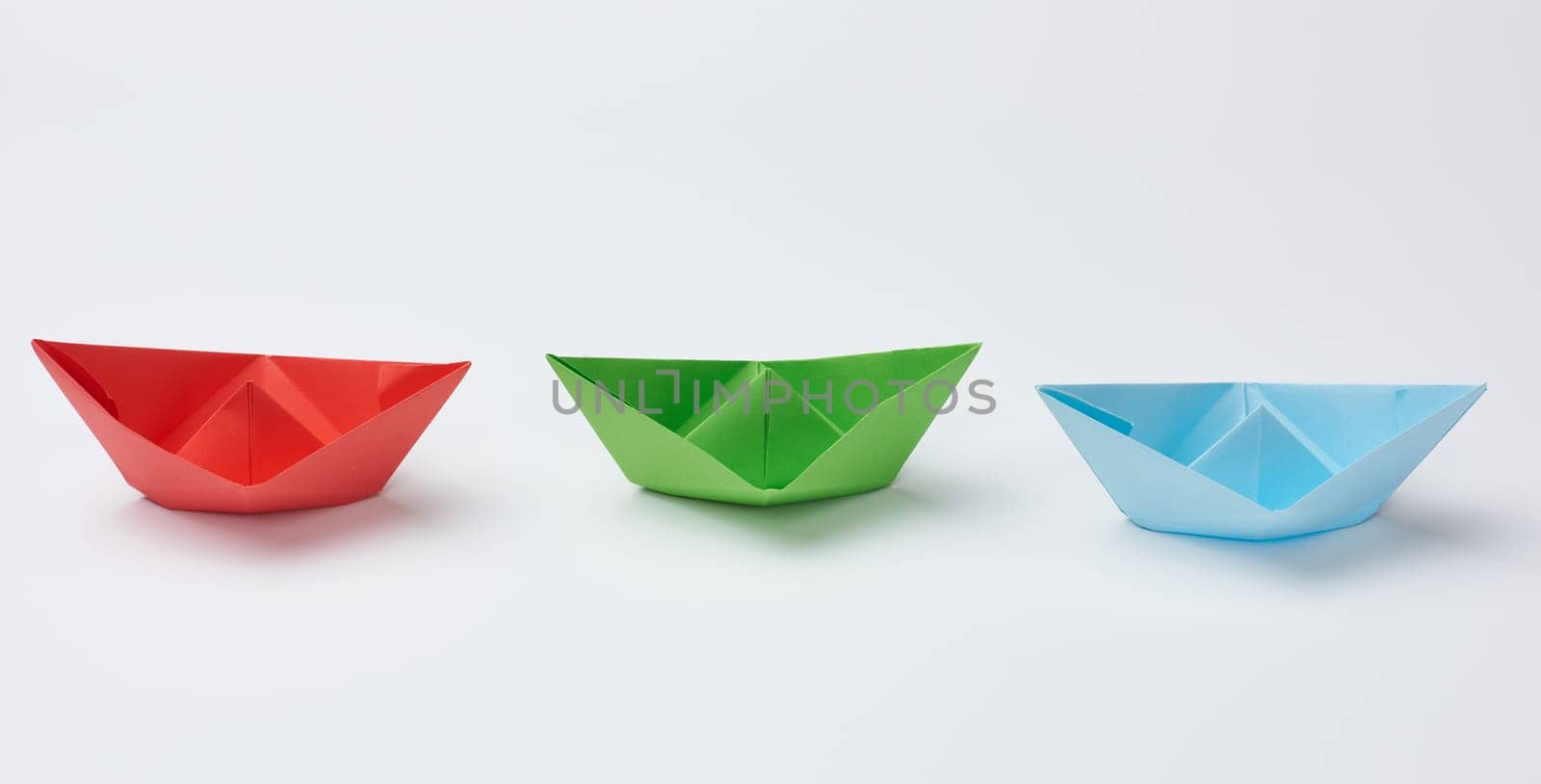 Three paper boats on a white background by ndanko