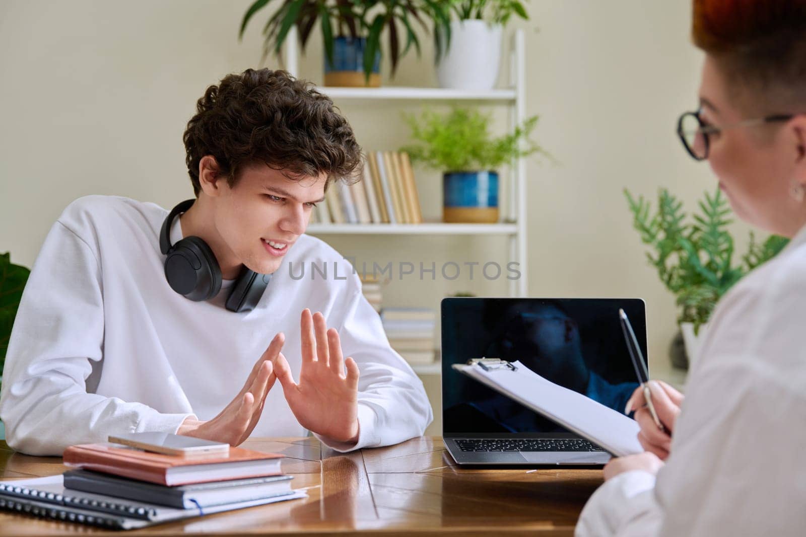 Young man university college student at meeting with female professional mental therapist, social worker, counselor, behavior. Psychology therapy help counseling treatment support, mental health