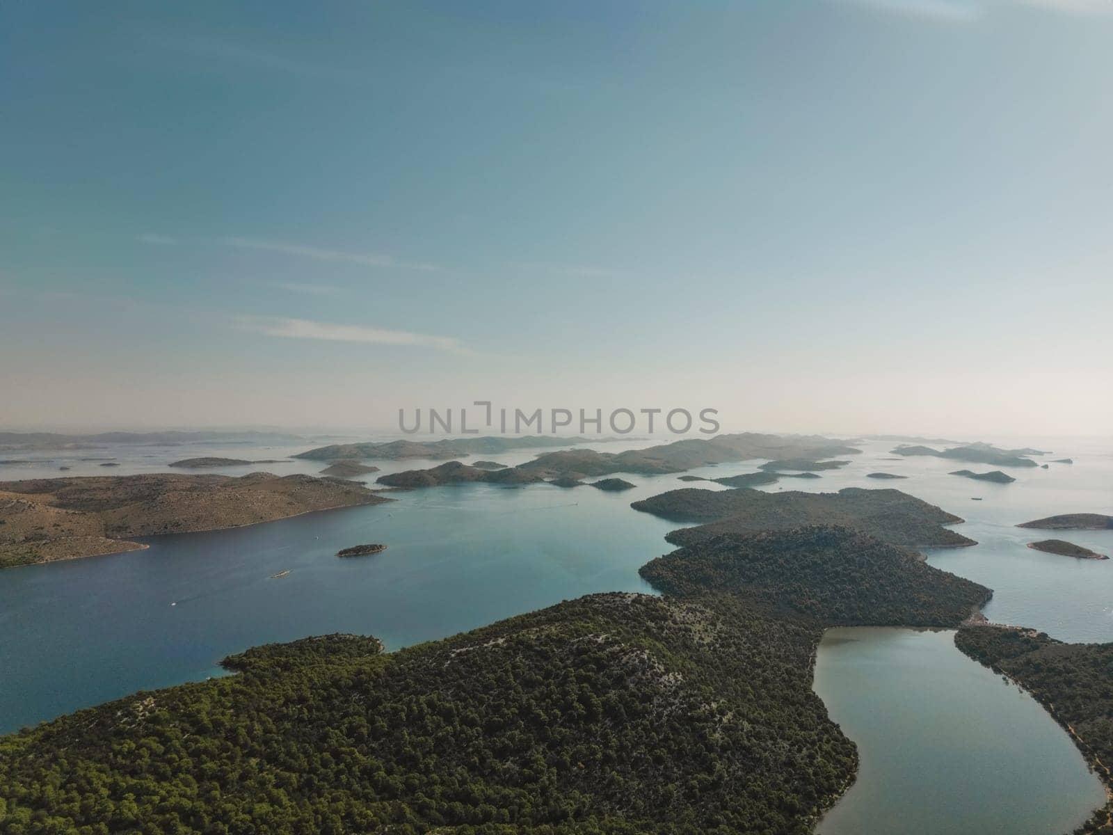 Drone summer view of Telascica bay in National Park, Croatia. Small narrow rocky land, islands and water to horizon in Dalmatian coast