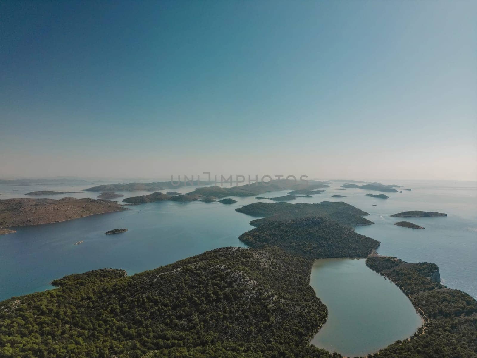 Drone aerial view of sunny landscape with sea inlets and islands of Telascica bay in National Park, Croatia