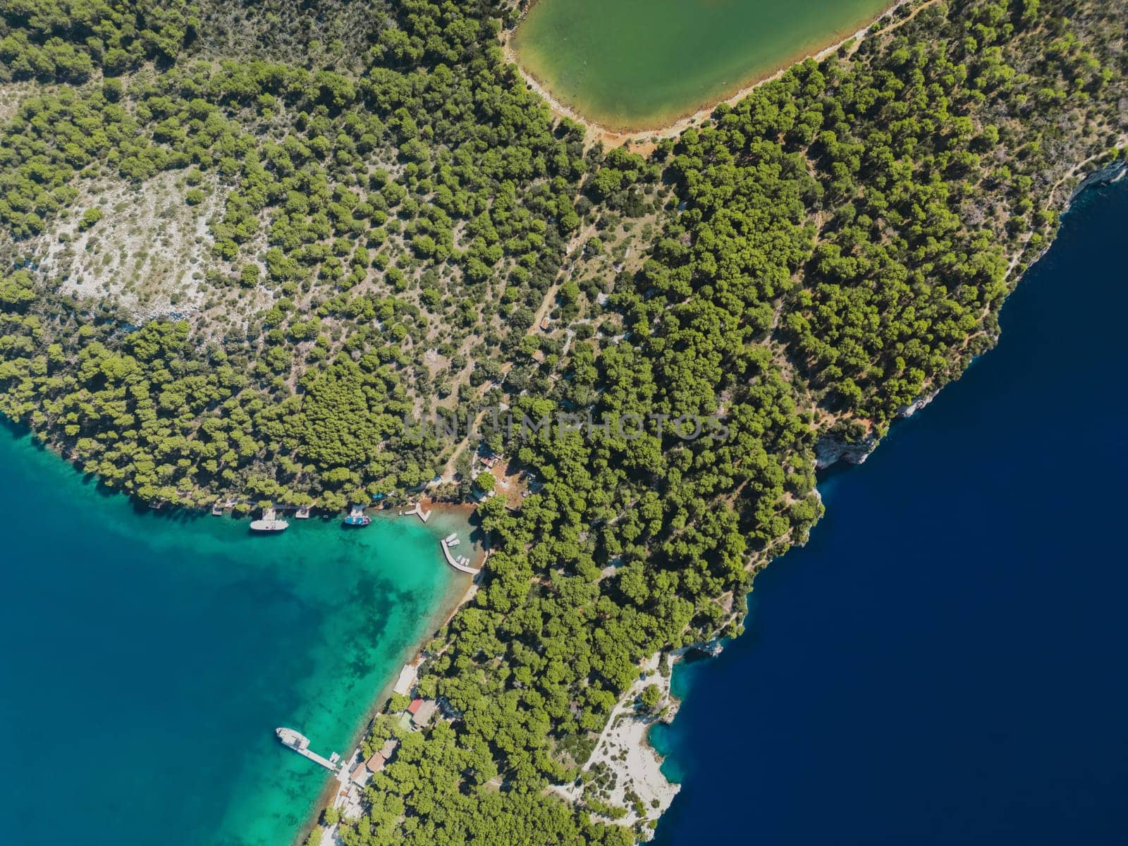 Aerial drone top view photo of deep turquoise and emerald blue water and land in Telascica National Park, Croatia