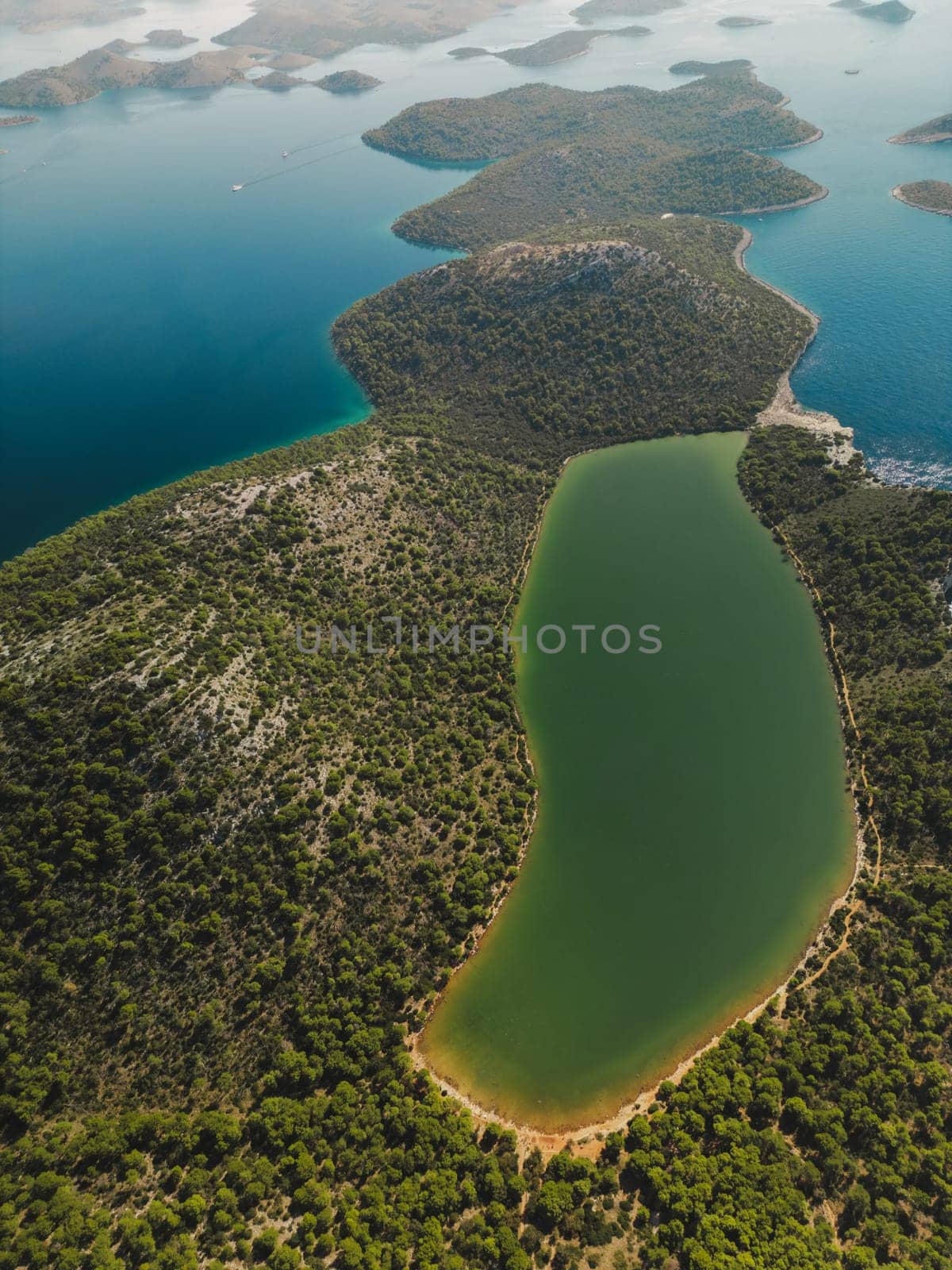 Drone aerial view of summer forest and lake with turquoise water, Telascica National Park, Croatia