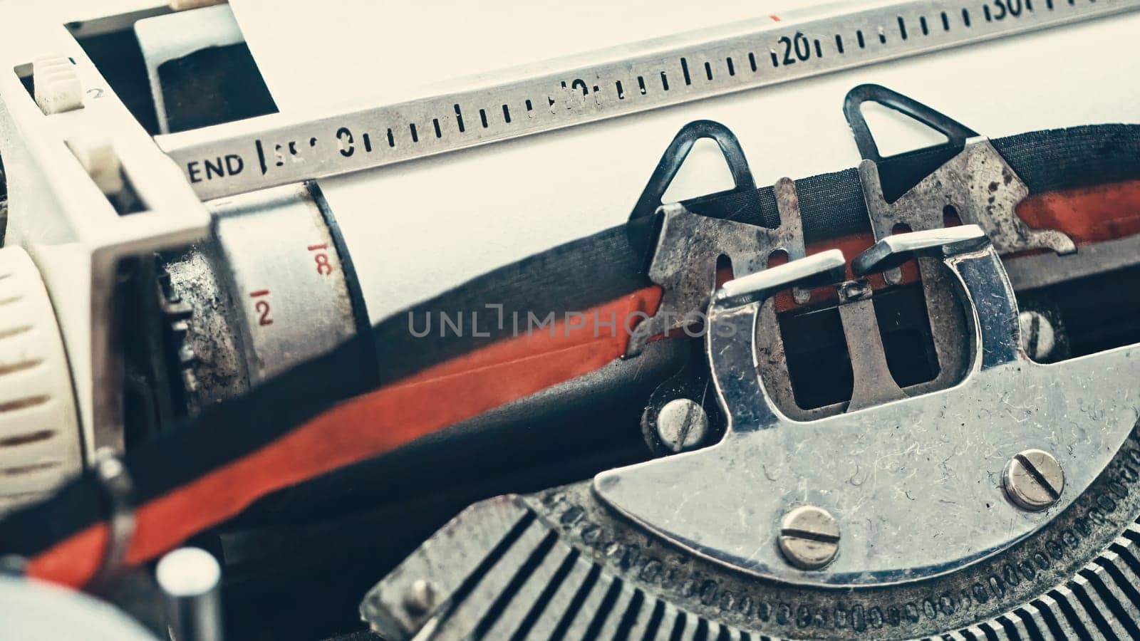 Vintage typewriter with with empty paper, close up view