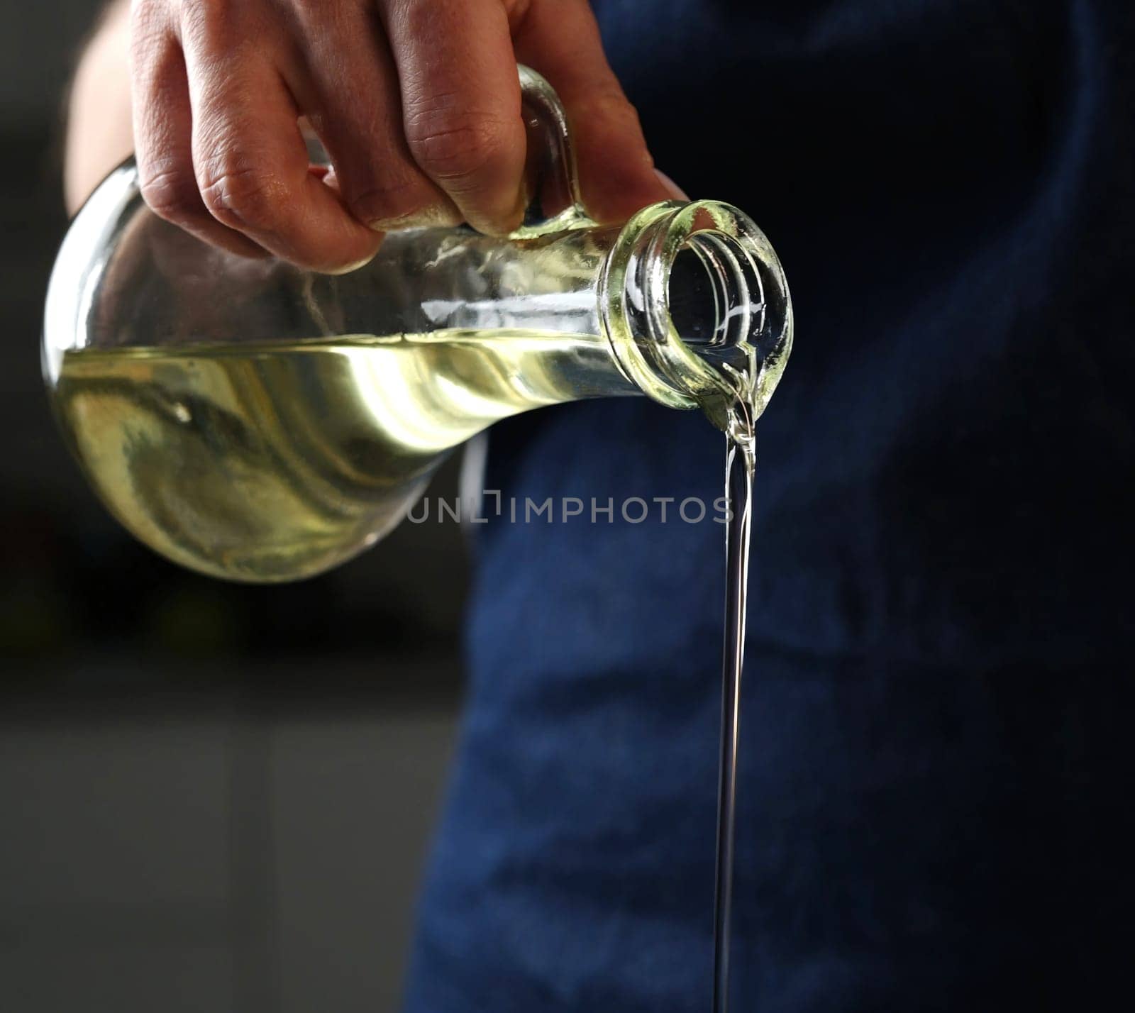 Girl Pouring Oil While Cooking Food, Vegetable Oil Is Poured From A Jug